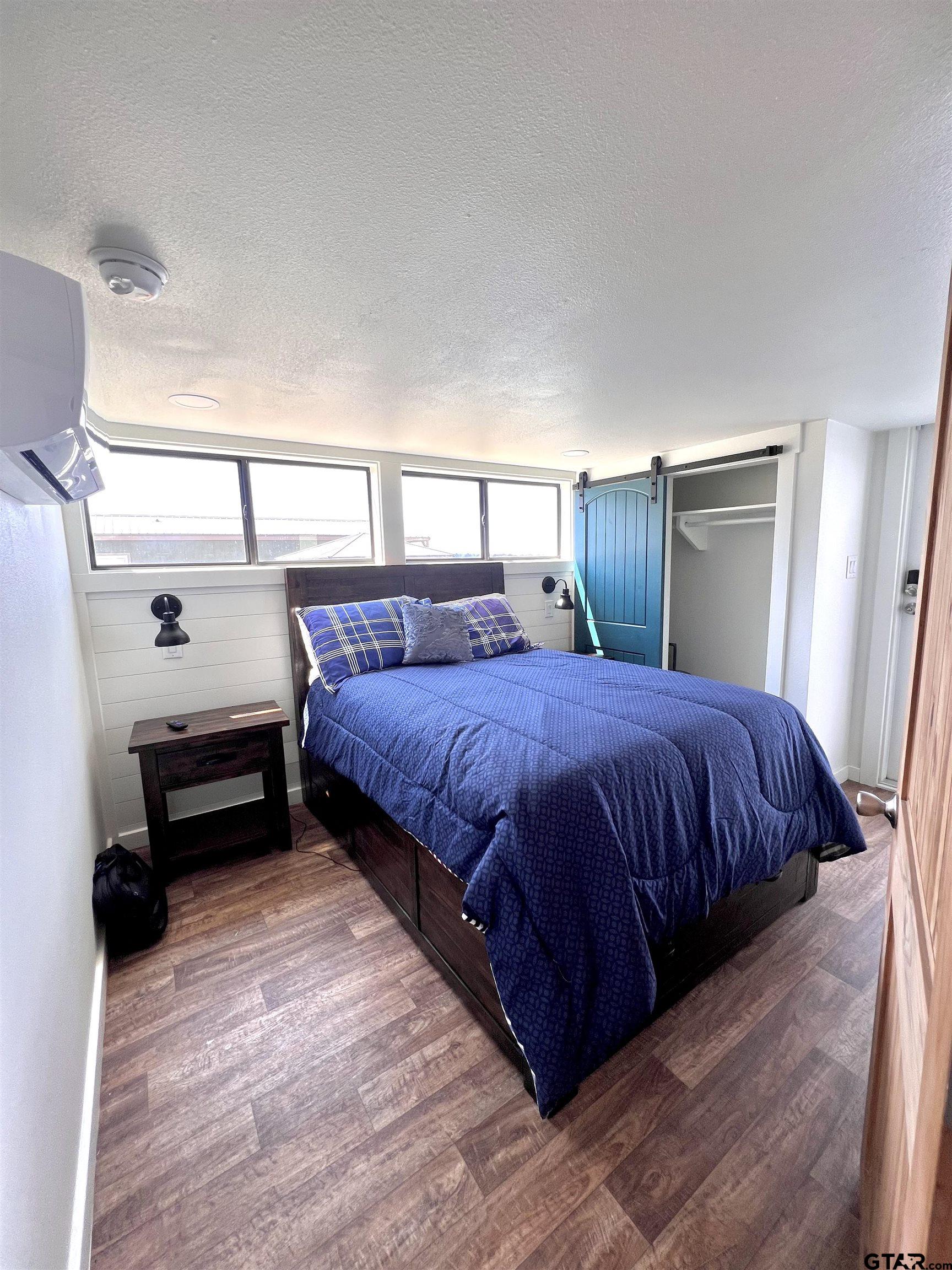 3235 County Road Cookville, TX 75558 - Photo 32 of 38 a bedroom with a bed and a night stand