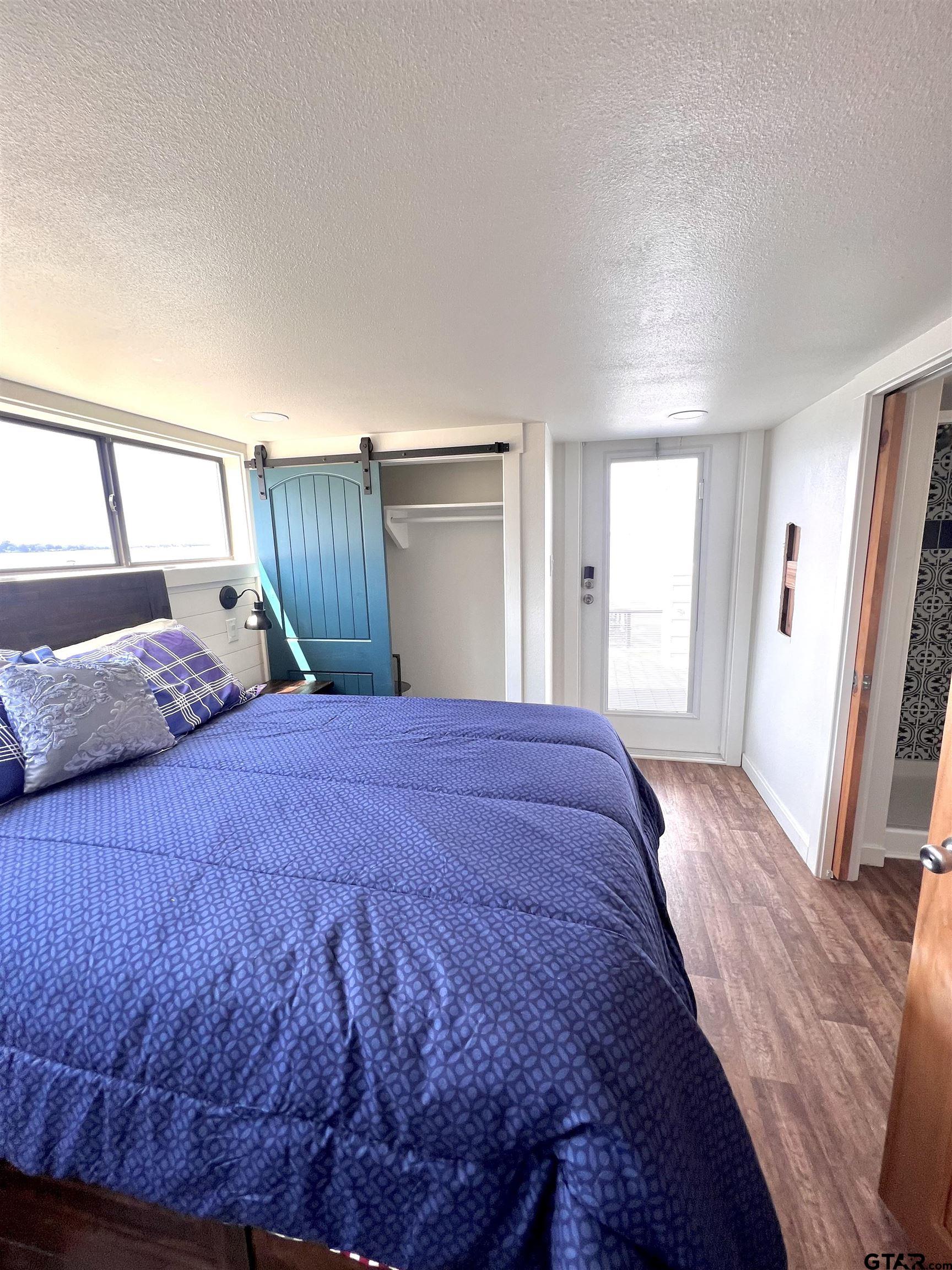 3235 County Road Cookville, TX 75558 - Photo 33 of 38 a bedroom with a bed and a mirror