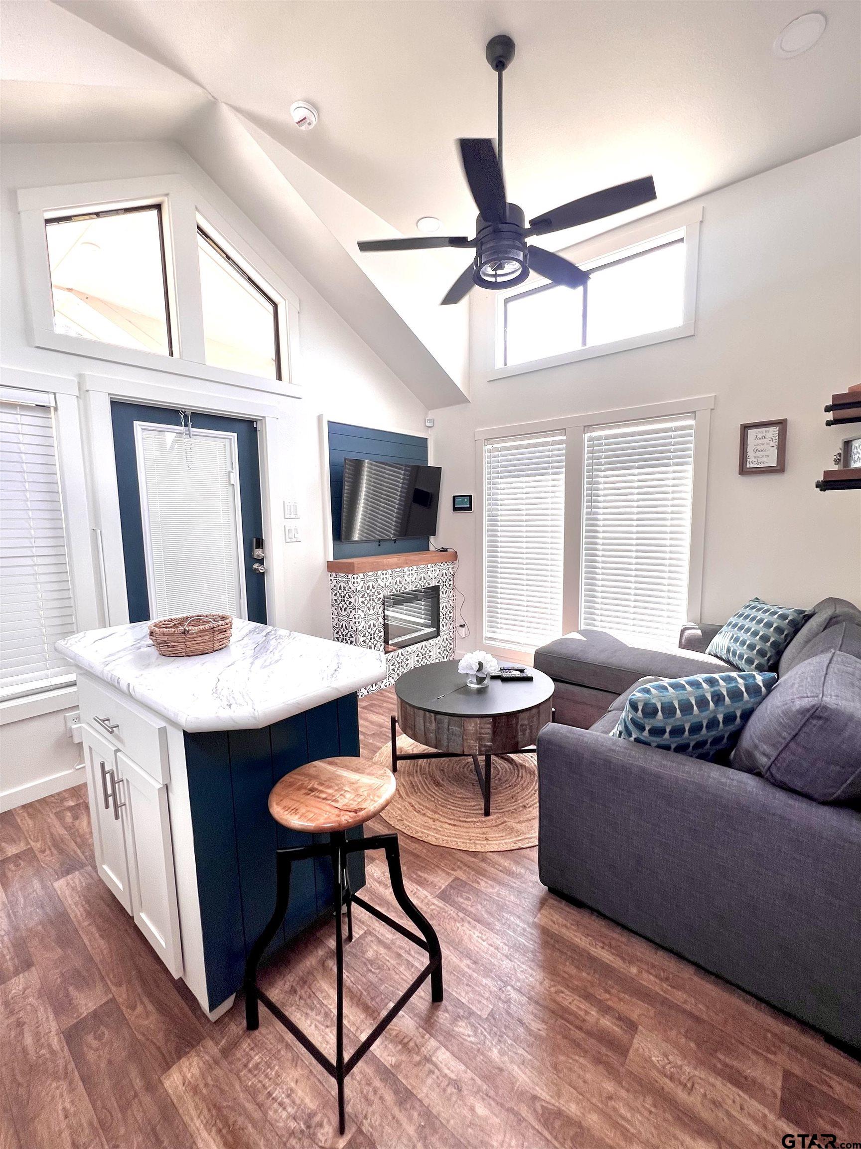 3235 County Road Cookville, TX 75558 - Photo 37 of 38 a living room with furniture a fireplace and a flat screen tv