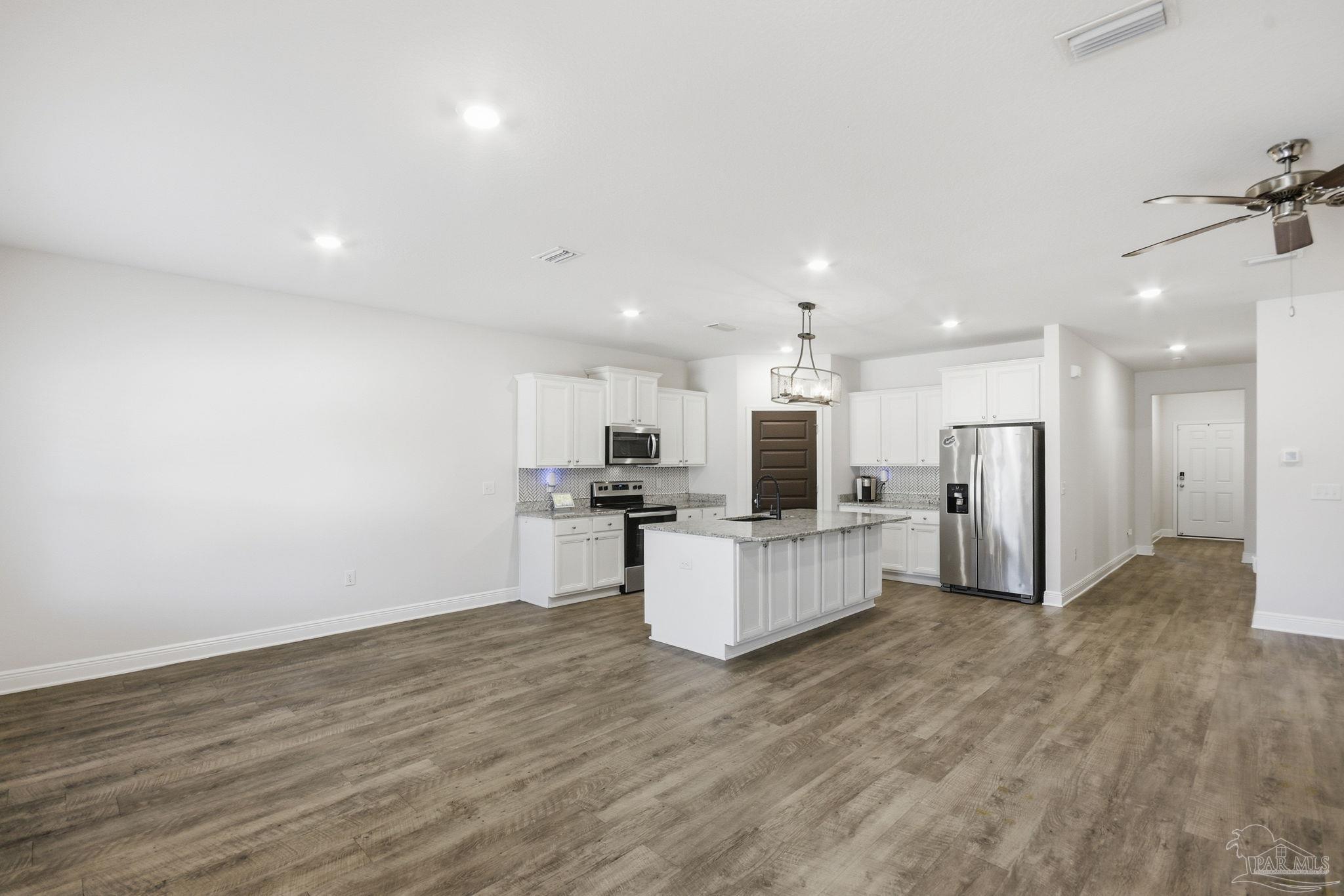 8038 Burnside Loop Pensacola, FL 32526 - Photo 12 of 48 a view of kitchen with stainless steel appliances microwave refrigerator and microwave