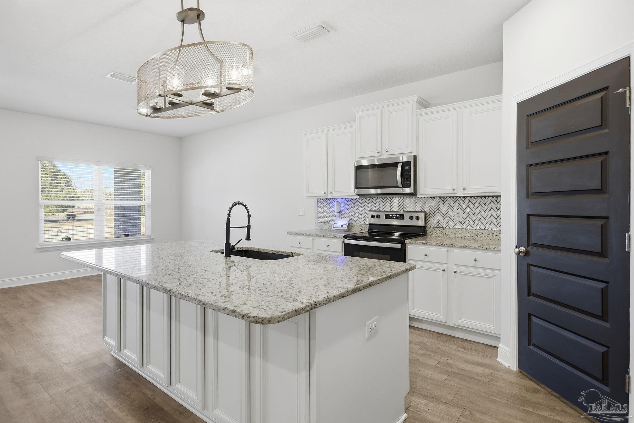 8038 Burnside Loop Pensacola, FL 32526 - Photo 13 of 48 a kitchen with stainless steel appliances granite countertop a stove and a sink