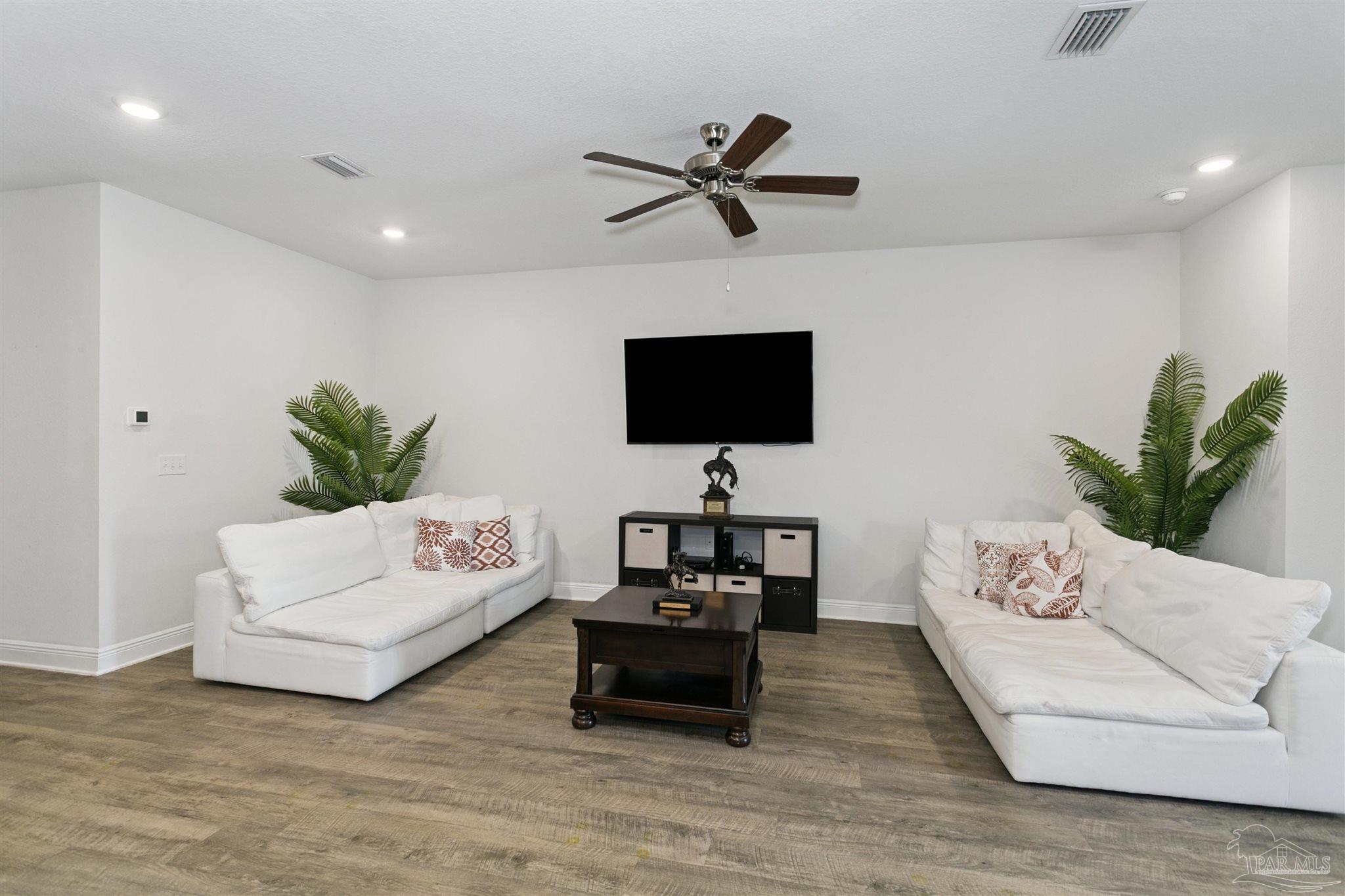 8038 Burnside Loop Pensacola, FL 32526 - Photo 18 of 48 a living room with furniture and a flat screen tv