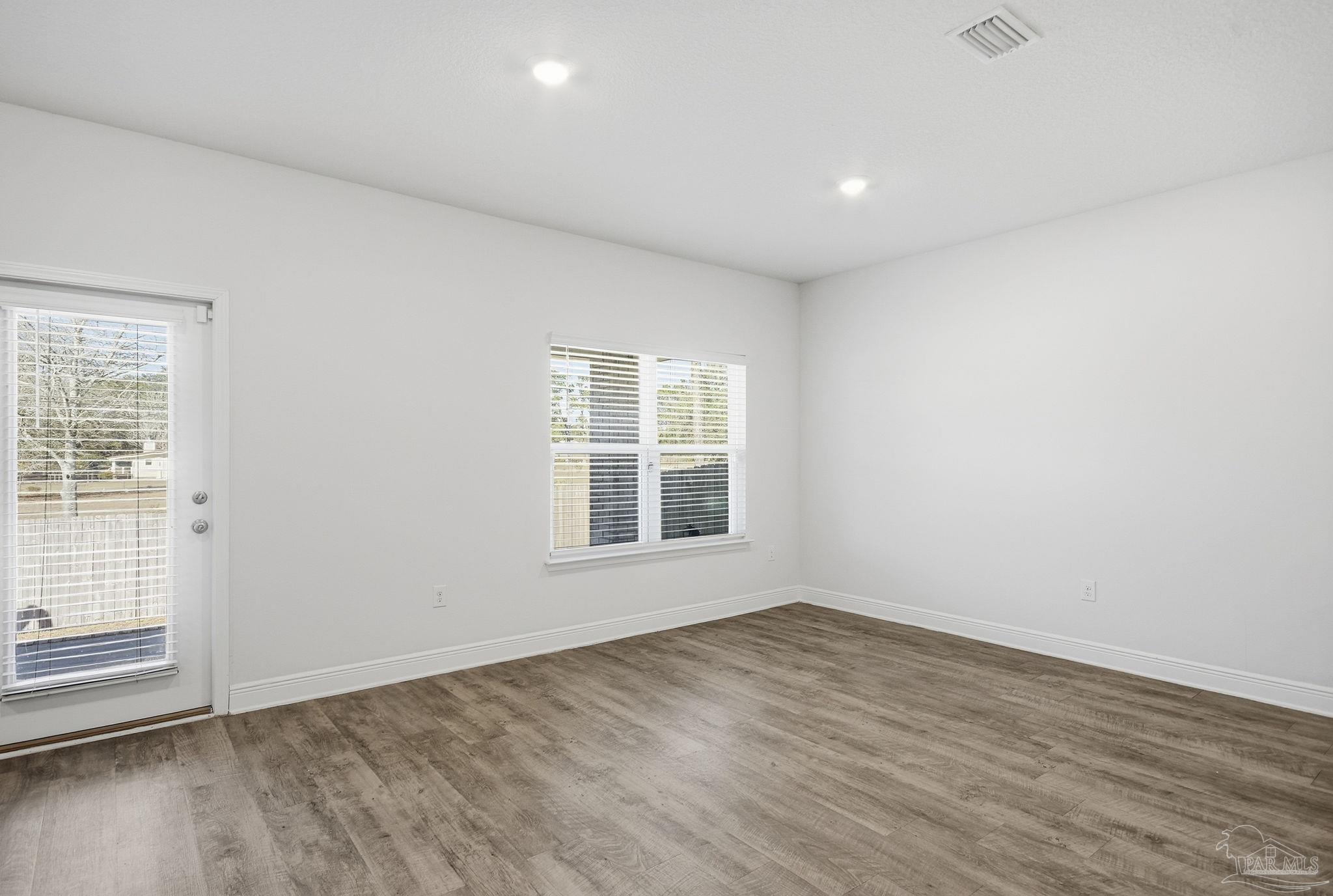 8038 Burnside Loop Pensacola, FL 32526 - Photo 19 of 48 an empty room with wooden floor and windows
