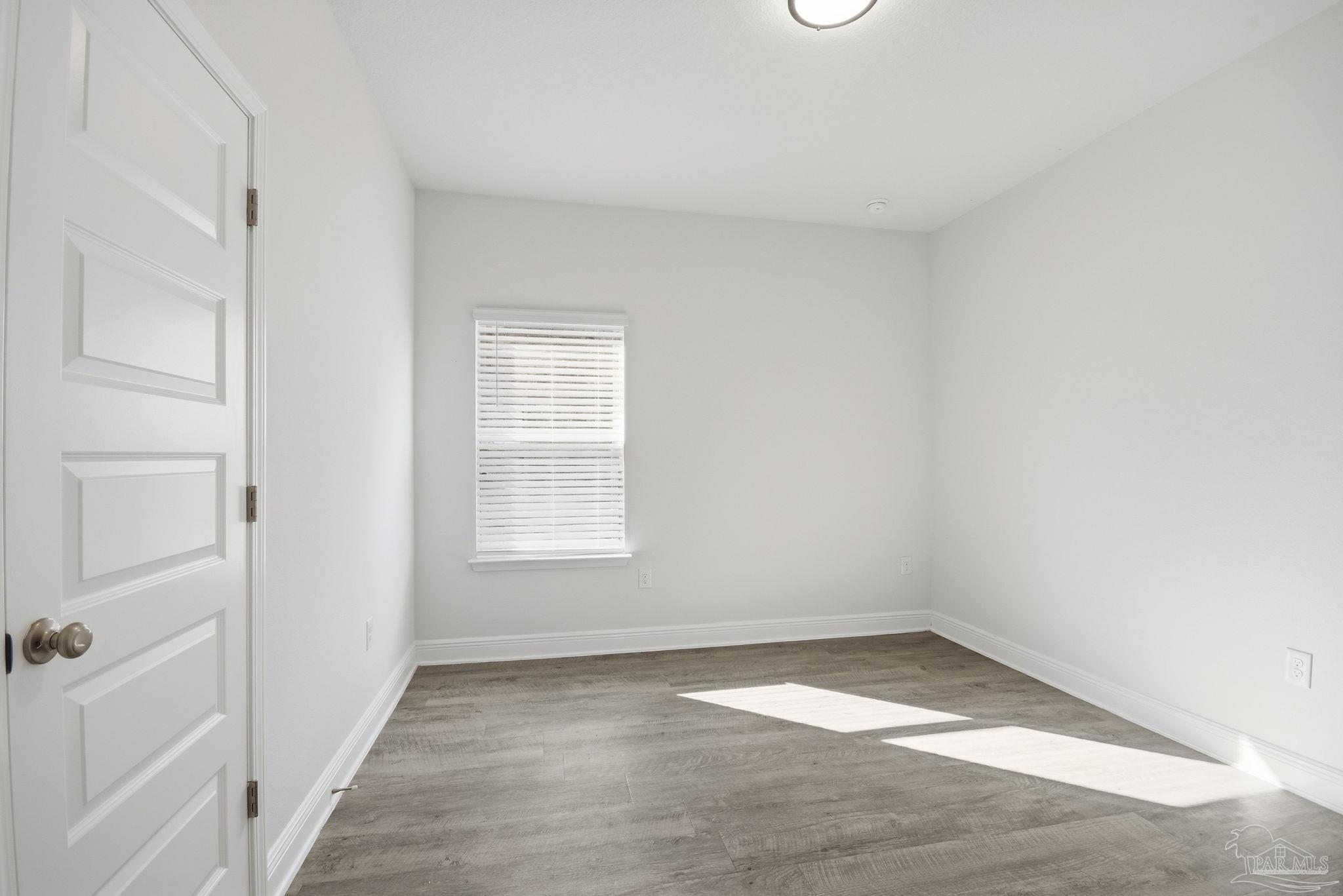 8038 Burnside Loop Pensacola, FL 32526 - Photo 30 of 48 a view of empty room with wooden floor
