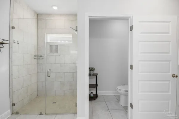a bathroom with a shower and toilet