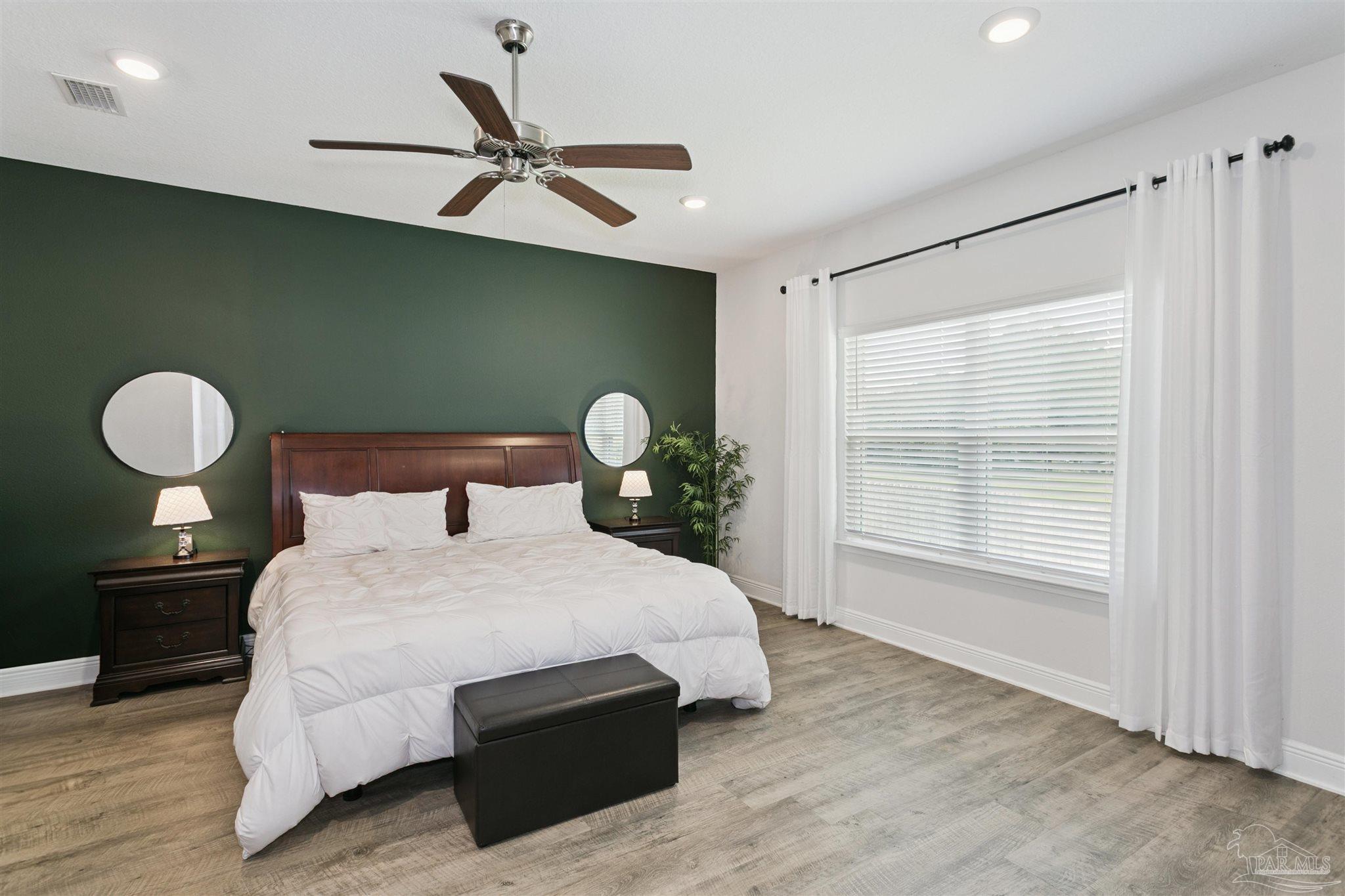 8038 Burnside Loop Pensacola, FL 32526 - Photo 32 of 48 a bedroom with a bed and window