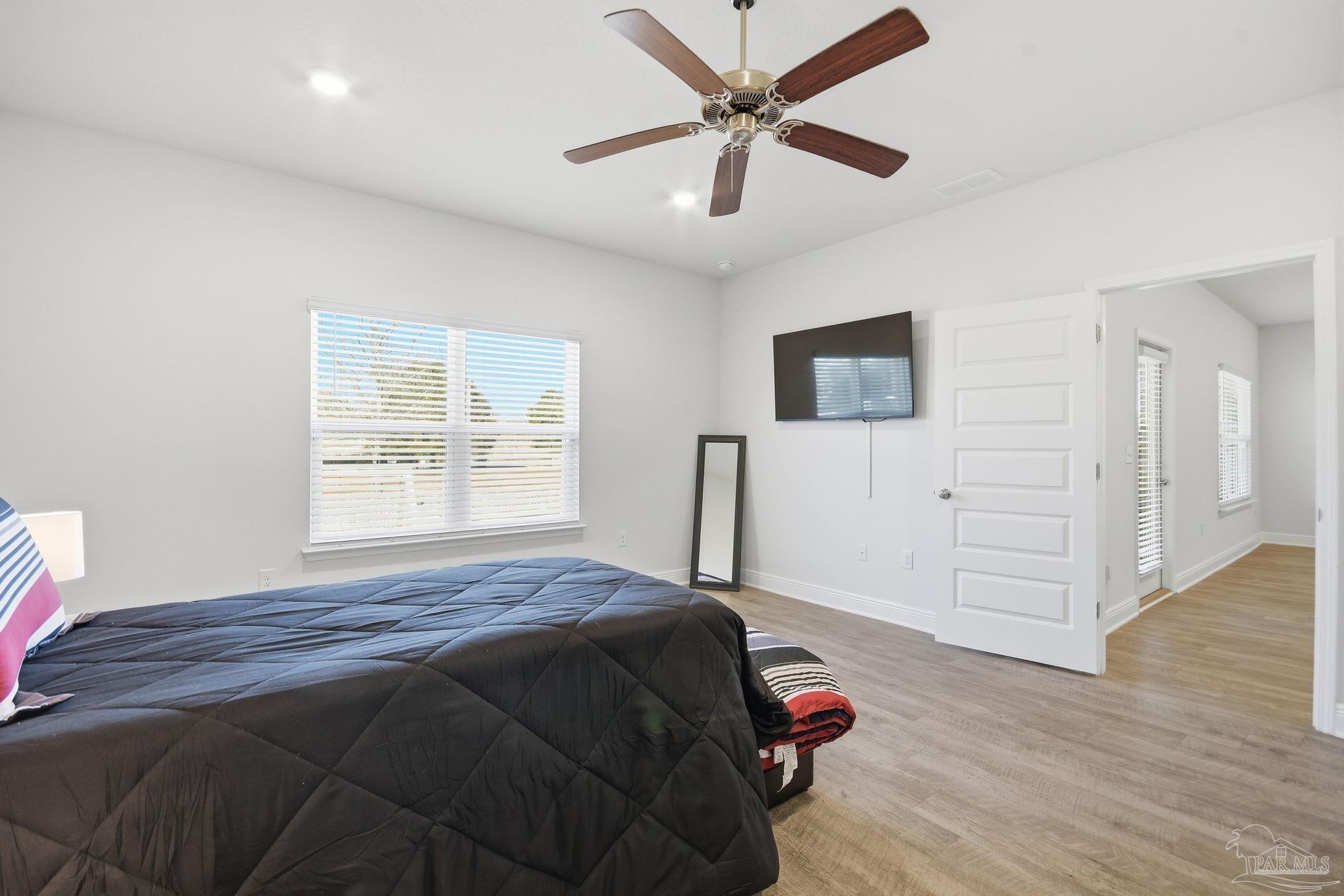 8038 Burnside Loop Pensacola, FL 32526 - Photo 34 of 48 a bedroom with a bed and a window