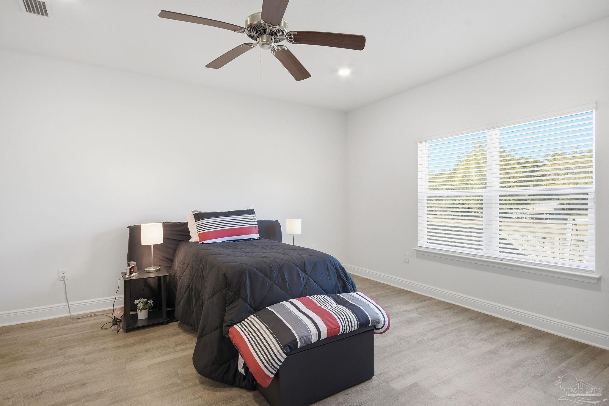 8038 Burnside Loop Pensacola, FL 32526 - Photo 39 of 48 a bedroom with a bed and window