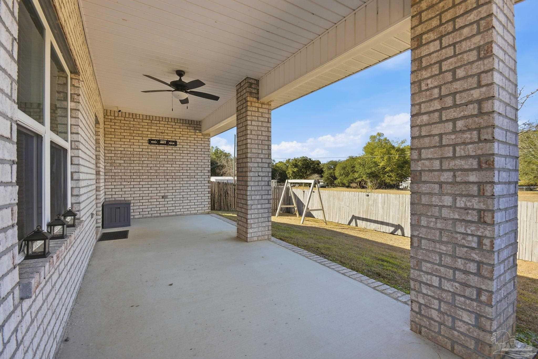 8038 Burnside Loop Pensacola, FL 32526 - Photo 40 of 48 a view of a porch with a floor to ceiling window and potted plants