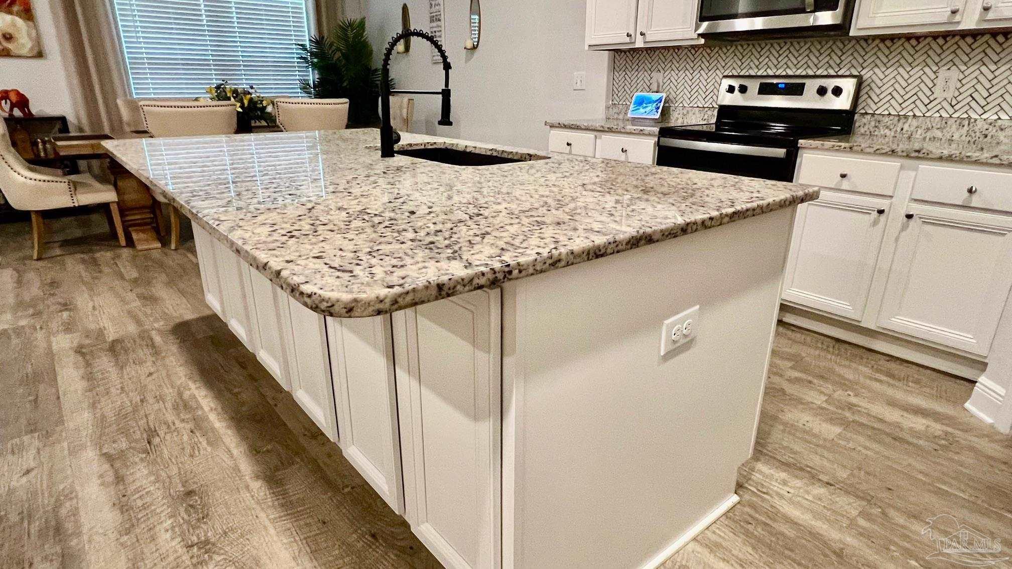 8038 Burnside Loop Pensacola, FL 32526 - Photo 8 of 48 a kitchen with granite countertop sink and cabinets