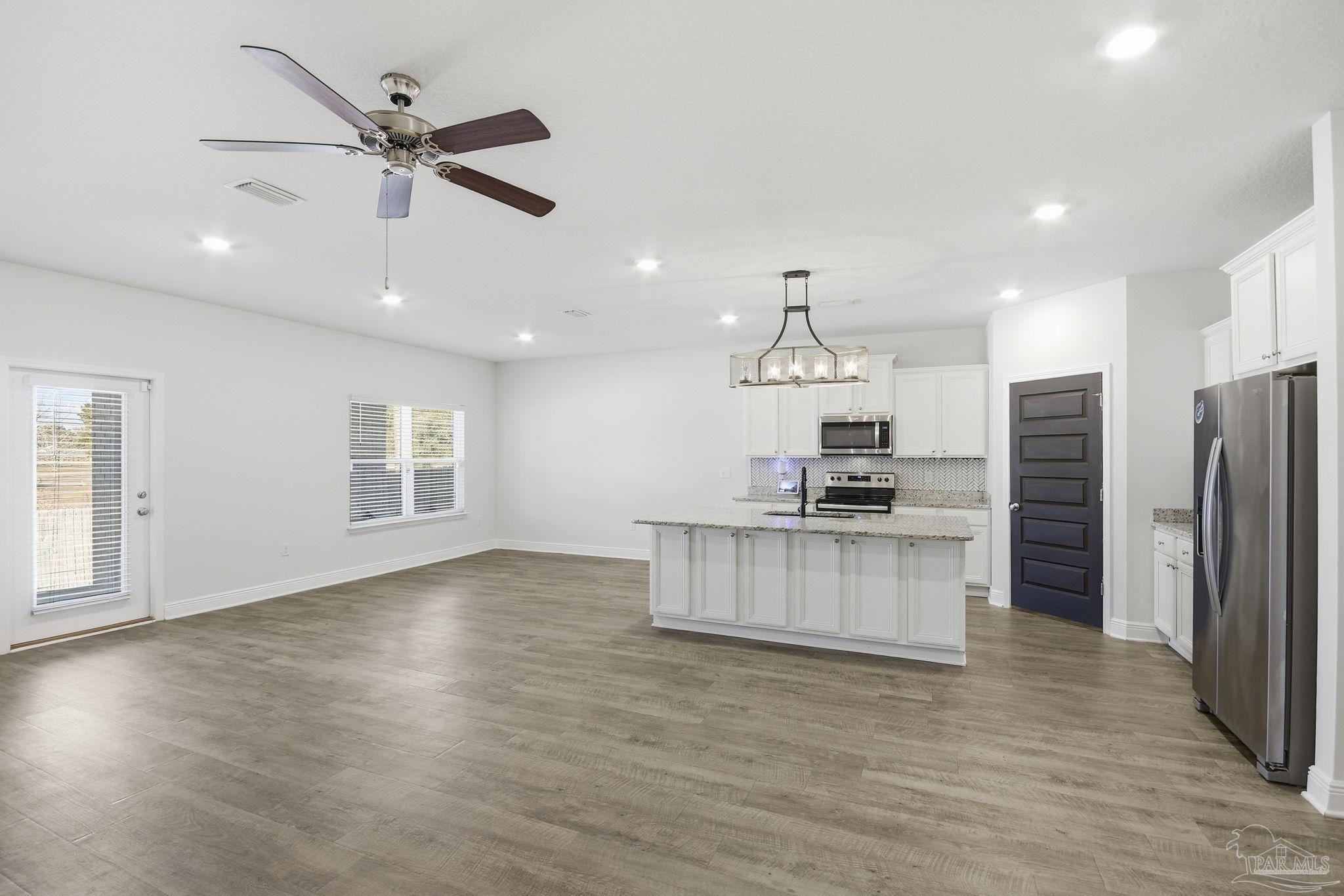 8038 Burnside Loop Pensacola, FL 32526 - Photo 10 of 48 an open kitchen with refrigerator and microwave
