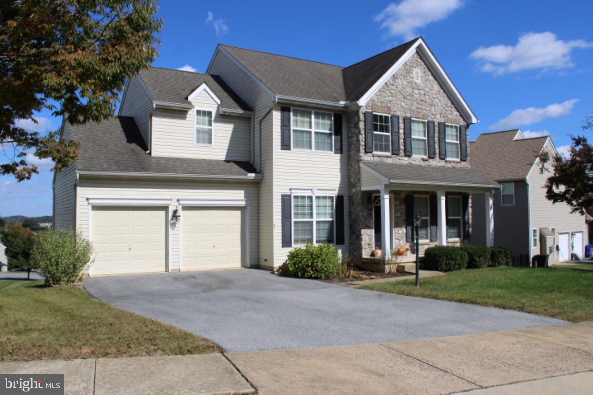 41 Logan Drive New Freedom, PA 17349 - Photo 2 of 27 a front view of a house with a yard and garage
