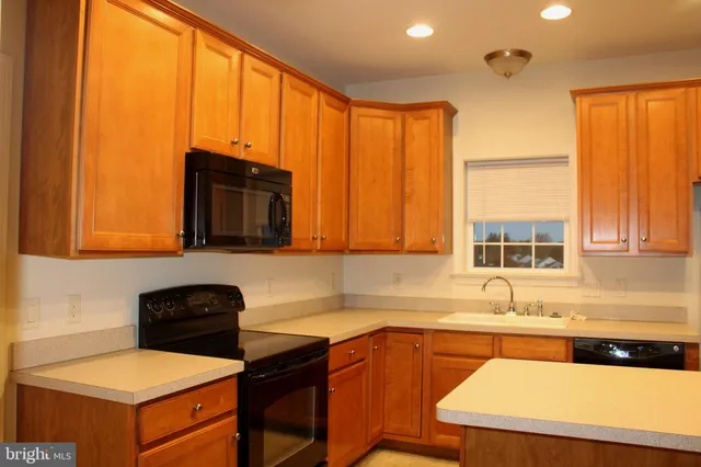 a kitchen with a sink a stove and a microwave