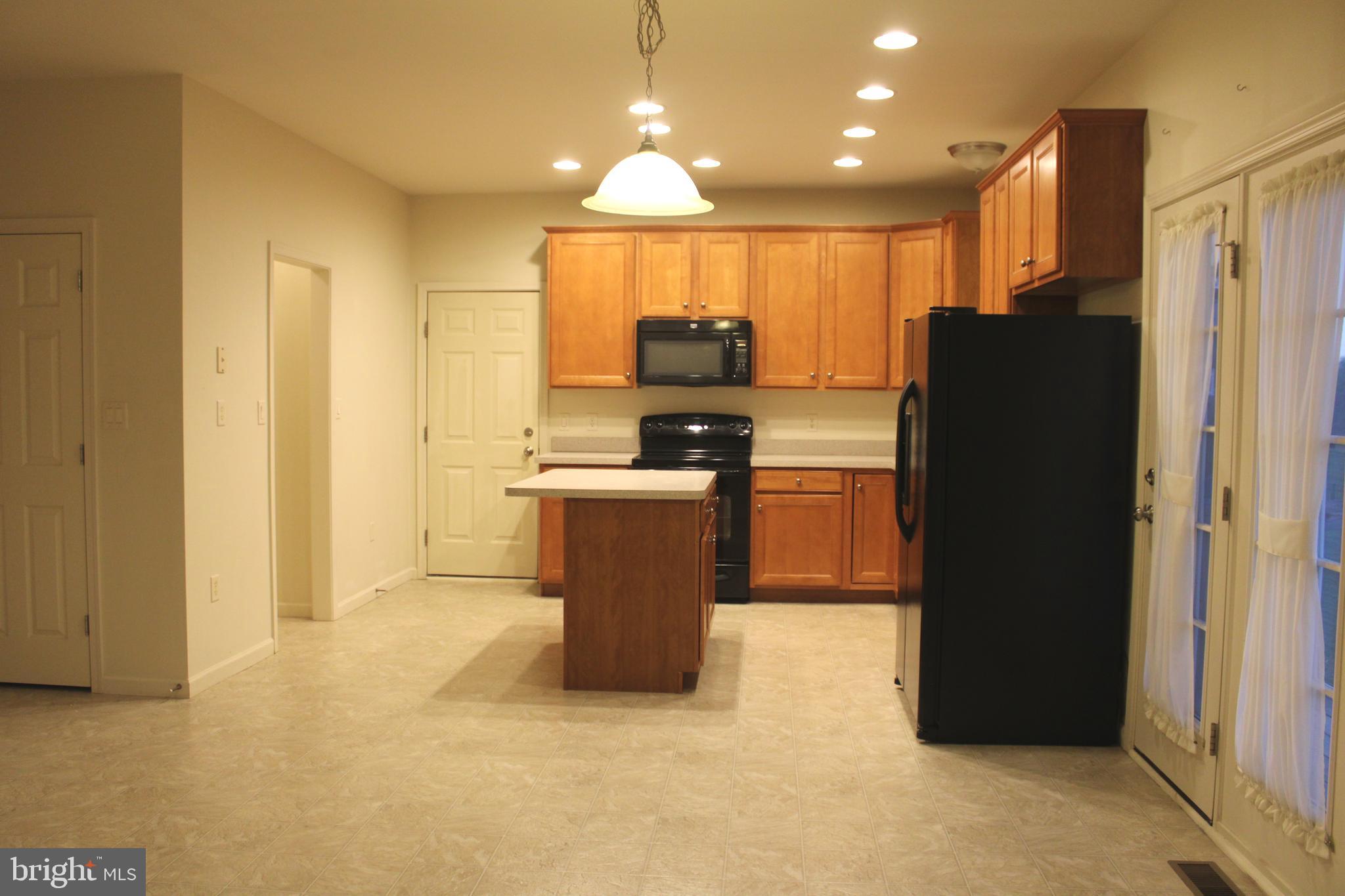 41 Logan Drive New Freedom, PA 17349 - Photo 5 of 27 a kitchen with a refrigerator and a stove top oven
