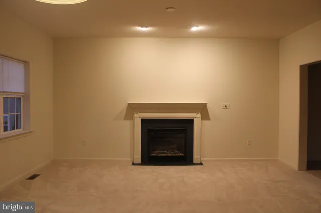 a view of empty room with a fireplace