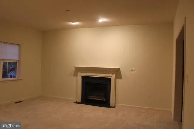 an empty room with a fireplace