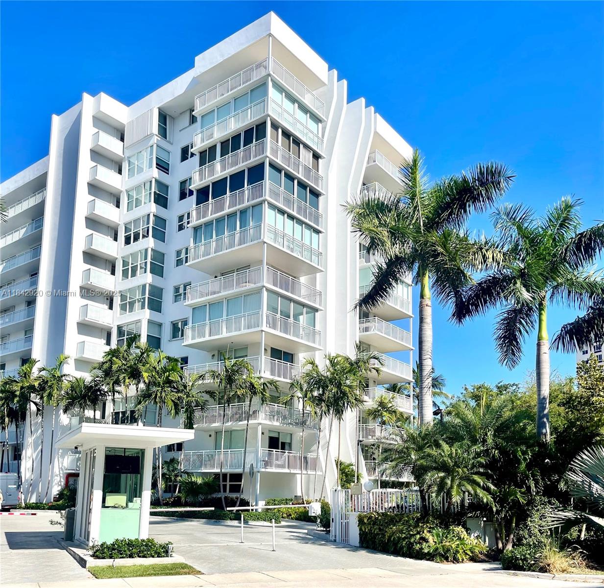 607 Ocean Drive, Unit 3K Key Biscayne, FL 33149 - Photo 1 of 18 a front view of multi story residential apartment building with yard and parking