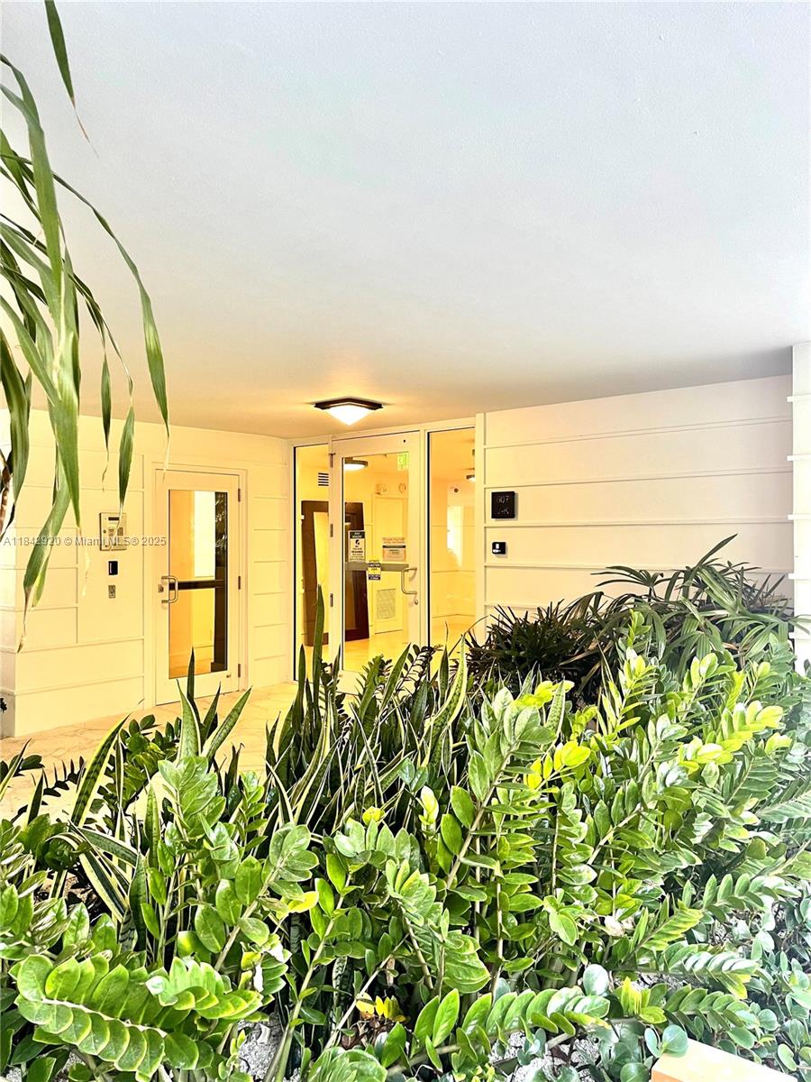 607 Ocean Drive, Unit 3K Key Biscayne, FL 33149 - Photo 11 of 18 a view of a pathway both side of building