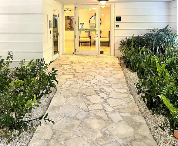 a kitchen with stainless steel appliances granite countertop a refrigerator a stove and a sink