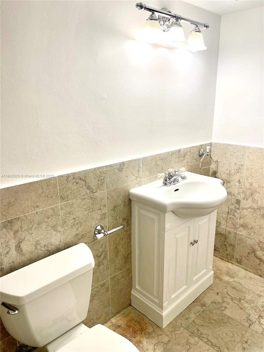 607 Ocean Drive, Unit 3K Key Biscayne, FL 33149 - Photo 18 of 18 a bathroom with a sink a toilet and shower
