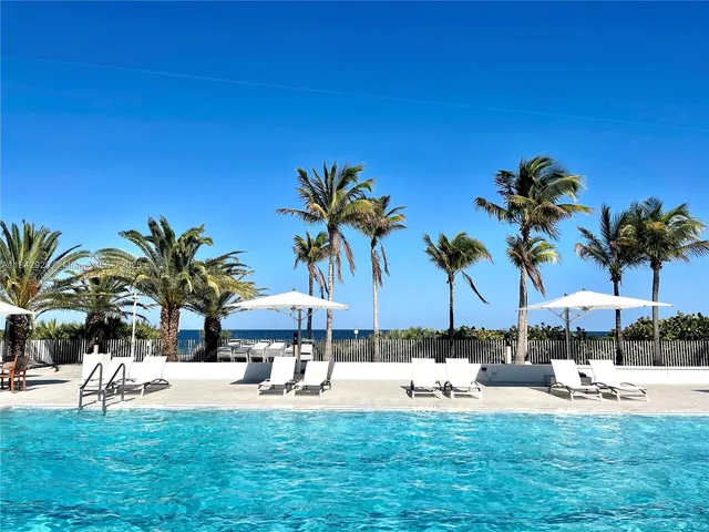a view of roof deck with palm trees
