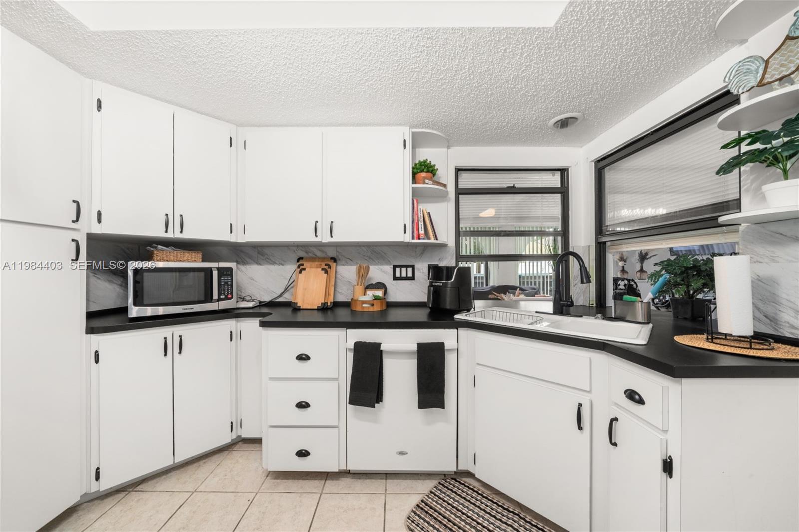 4201 Westminster Road Sebring, FL 33875 - Photo 12 of 43 a kitchen with stainless steel appliances a sink and a refrigerator