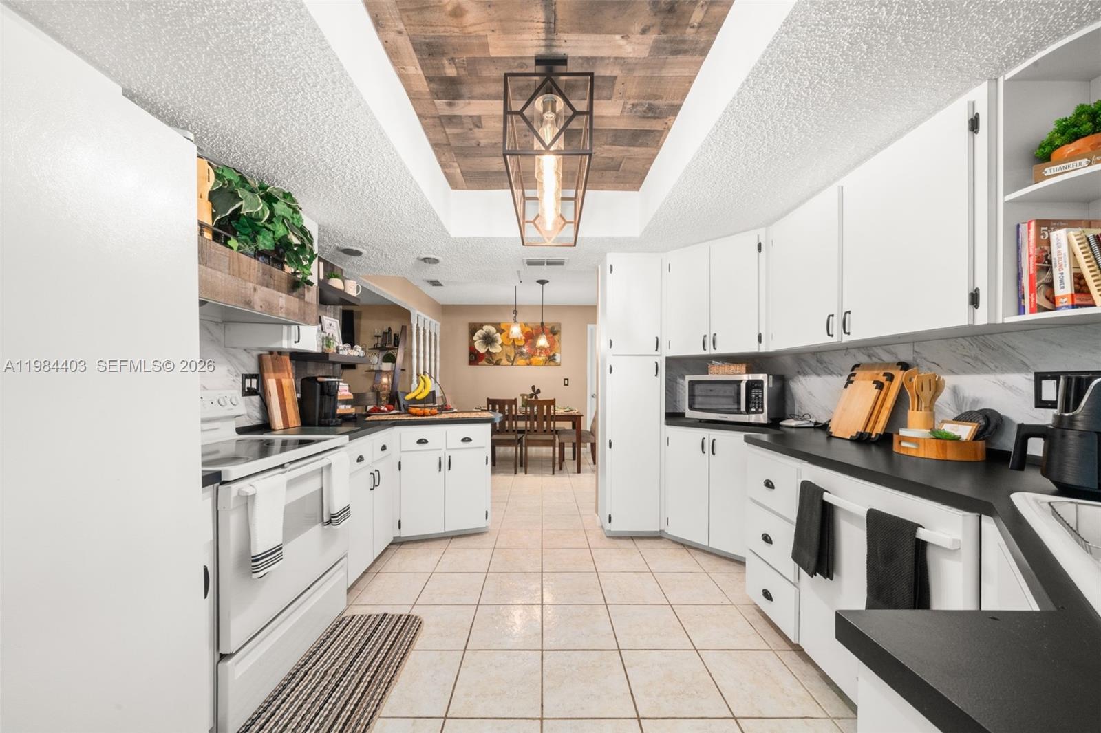 4201 Westminster Road Sebring, FL 33875 - Photo 13 of 43 a kitchen with stainless steel appliances granite countertop a sink and cabinets