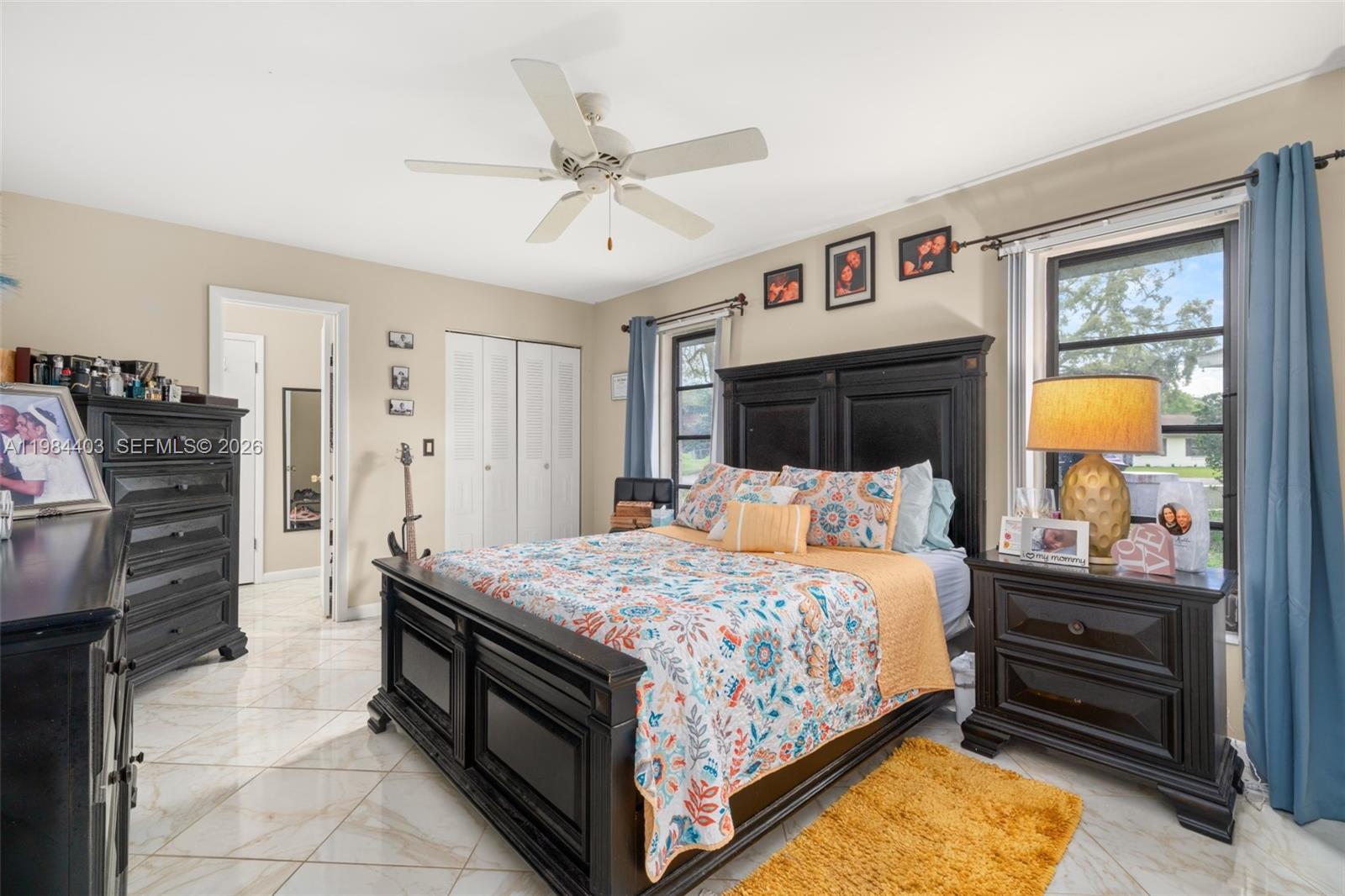 4201 Westminster Road Sebring, FL 33875 - Photo 16 of 43 a bedroom with a bed and a chandelier