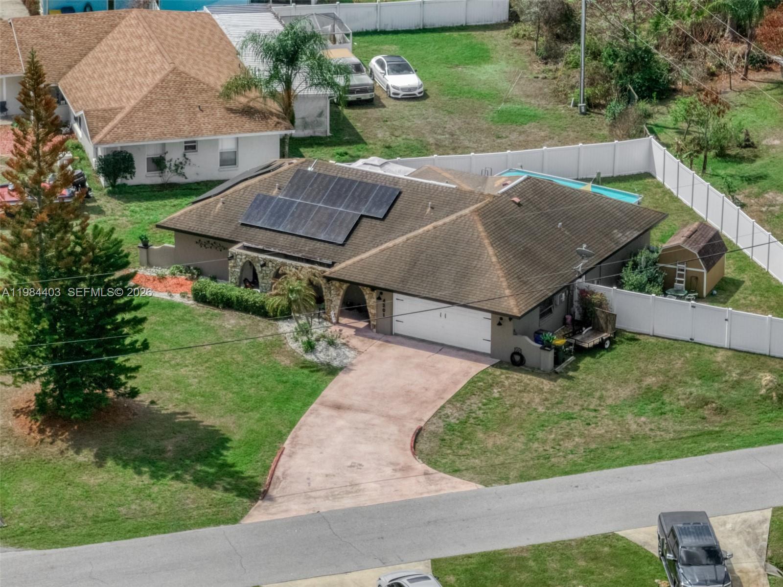 4201 Westminster Road Sebring, FL 33875 - Photo 37 of 43 an aerial view of a house with a yard table and chairs