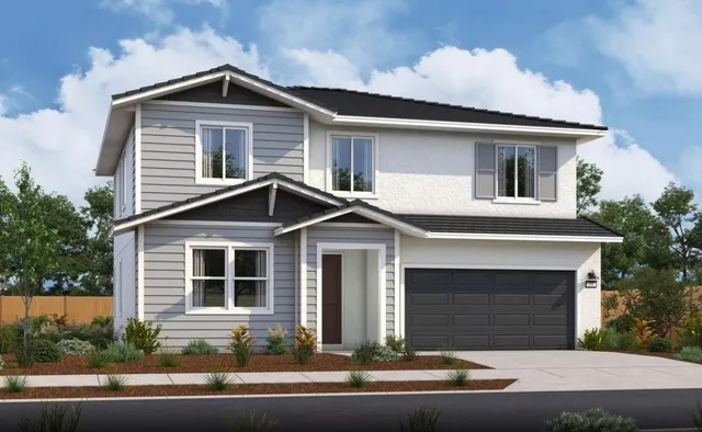 a front view of a house with garage