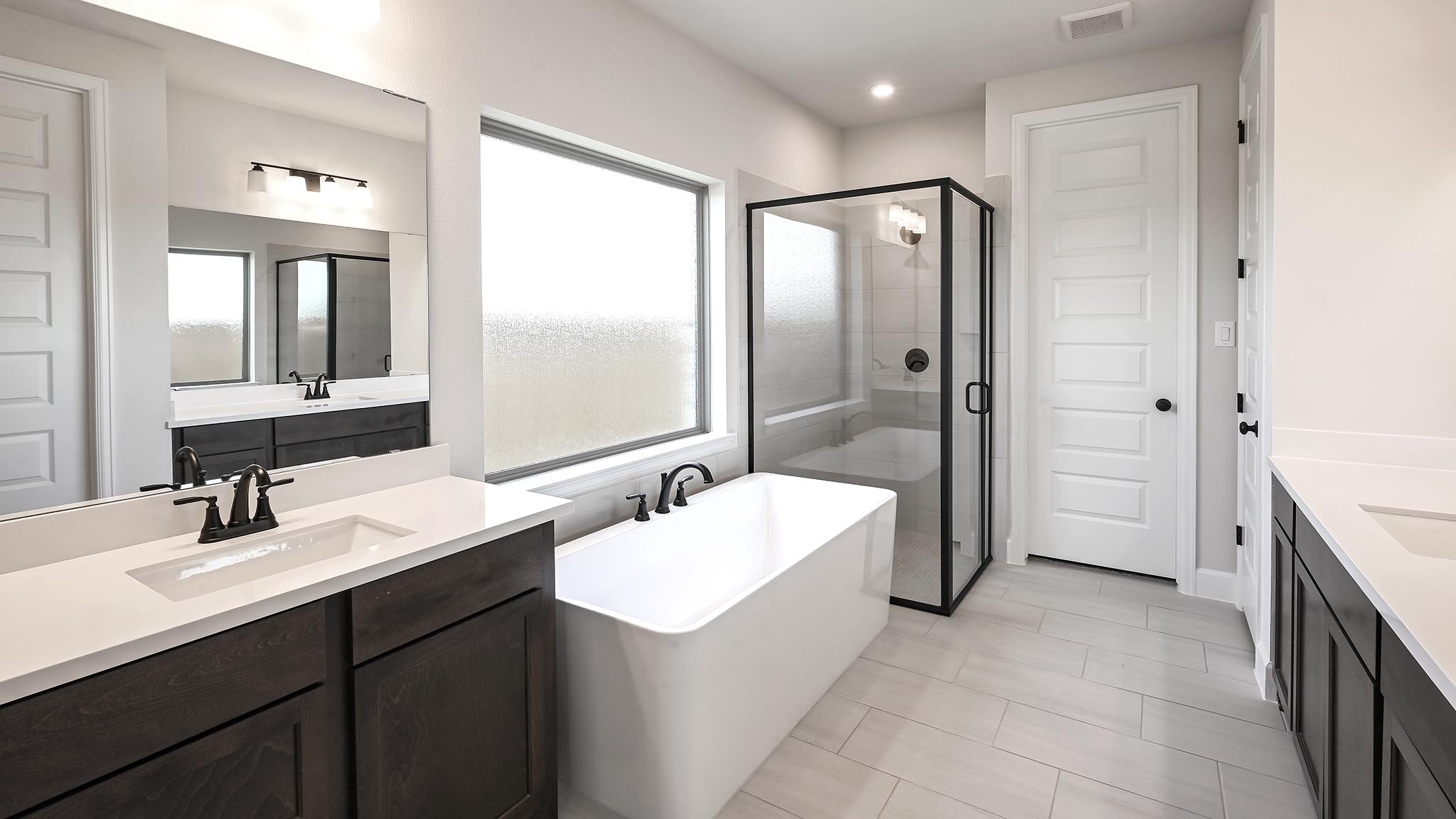 126 Basket Flower Loop Kyle, TX 78640 - Photo 16 of 29 a spacious bathroom with a bathtub shower sink and mirror