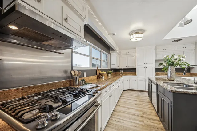 a kitchen with stove and cabinets