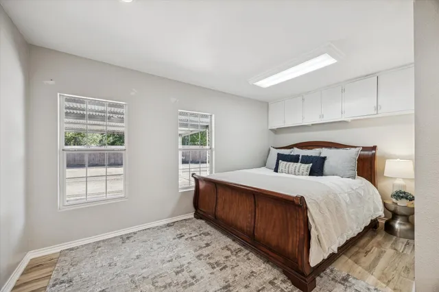 a spacious bedroom with a bed and a couch