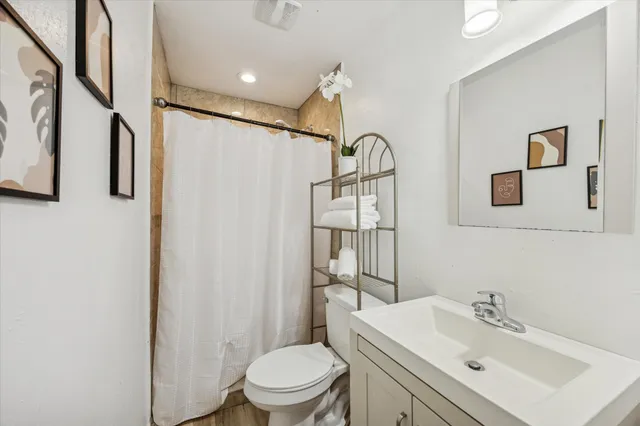 a living room with furniture a table and wooden floor