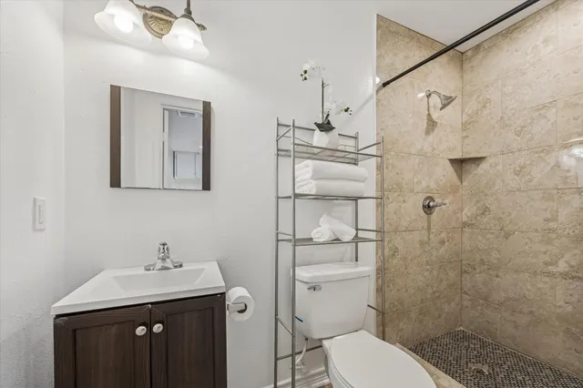 a living room with stainless steel appliances furniture and a flat screen tv