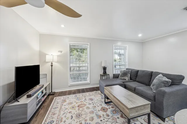a kitchen with stainless steel appliances granite countertop a white cabinets and wooden floor