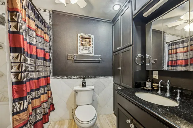 a bathroom with a sink a toilet a mirror and shower