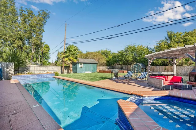 a building outdoor space with patio furniture and a potted plant