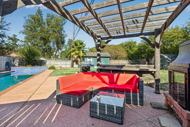 a view of a backyard with table and chairs a wooden fence