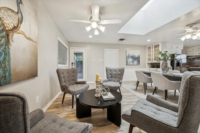a living room with furniture and kitchen view