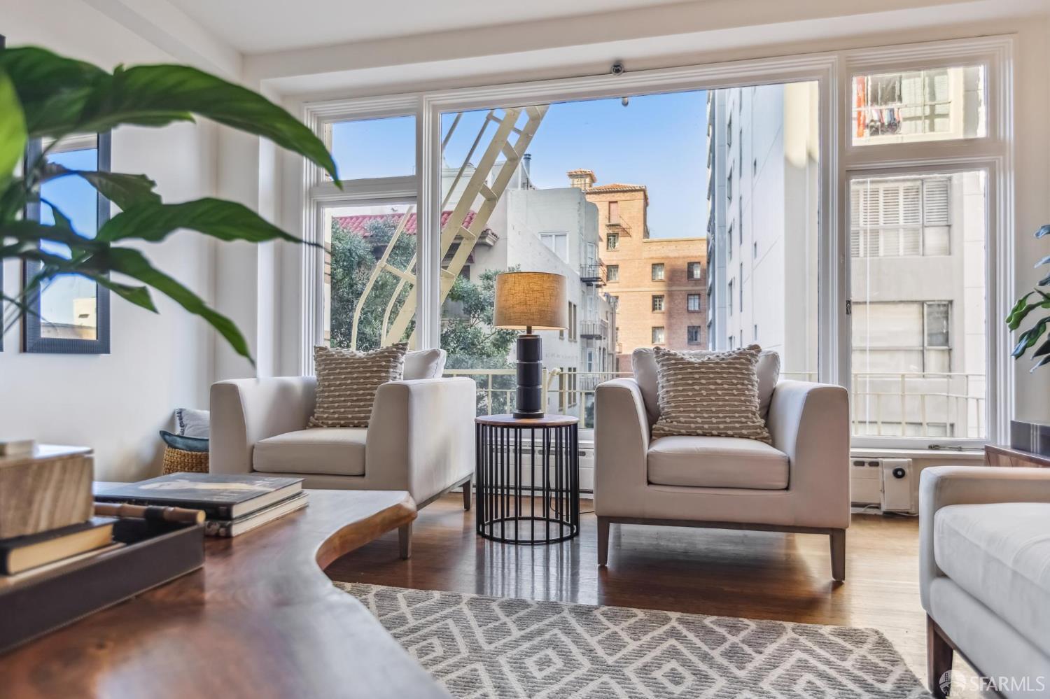 850 Powell Street, Unit 202 San Francisco, CA 94108 - Photo 13 of 51 a living room with furniture fireplace and a large window