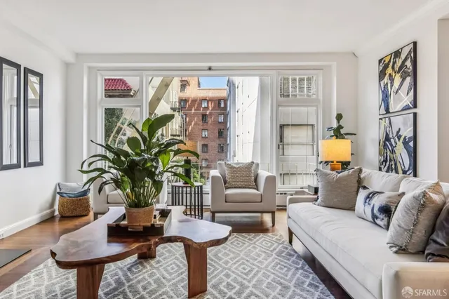 a living room with furniture and a potted plant