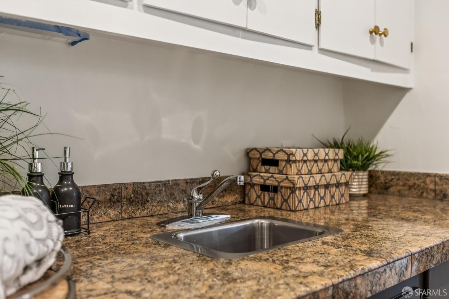 850 Powell Street, Unit 202 San Francisco, CA 94108 - Photo 26 of 51 a bathroom with a granite countertop sink and a mirror