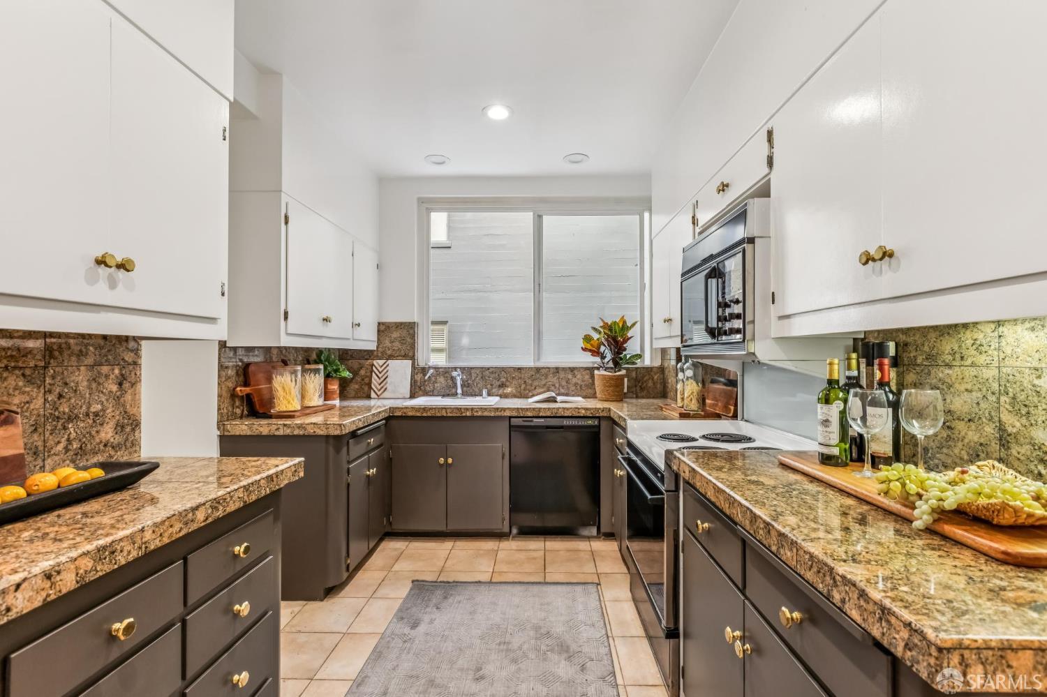 850 Powell Street, Unit 202 San Francisco, CA 94108 - Photo 28 of 51 a kitchen with a sink stove top oven and cabinets