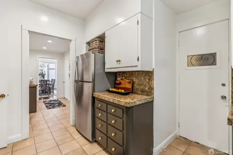 a kitchen with stainless steel appliances granite countertop a refrigerator and a stove