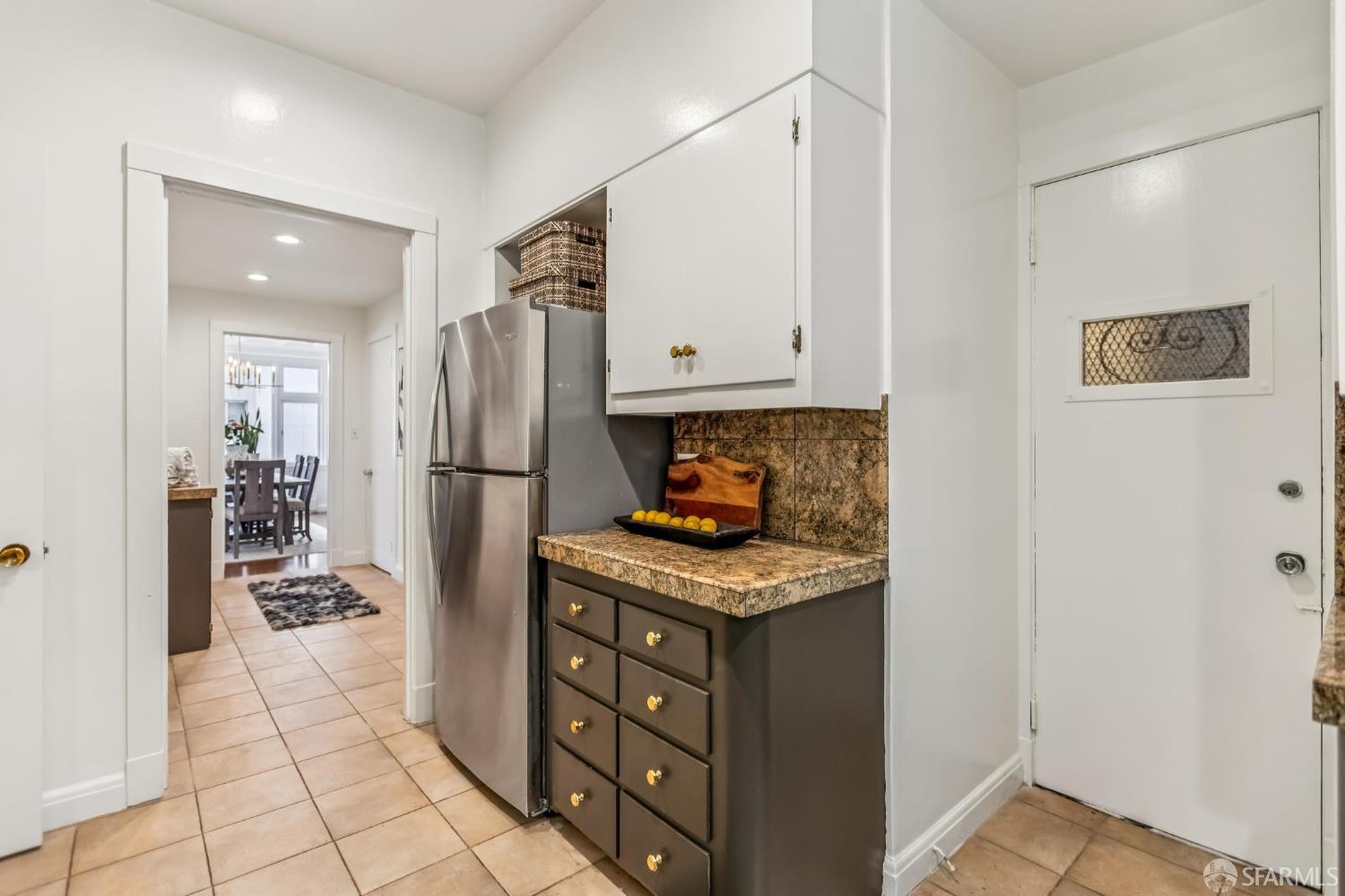 850 Powell Street, Unit 202 San Francisco, CA 94108 - Photo 31 of 51 a kitchen with stainless steel appliances granite countertop a refrigerator and a stove