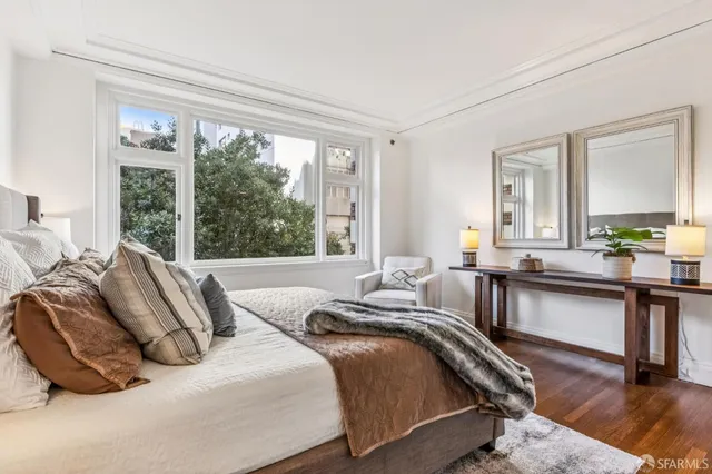 a bedroom with bed and a large window