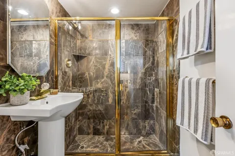 a bathroom with a shower and a sink