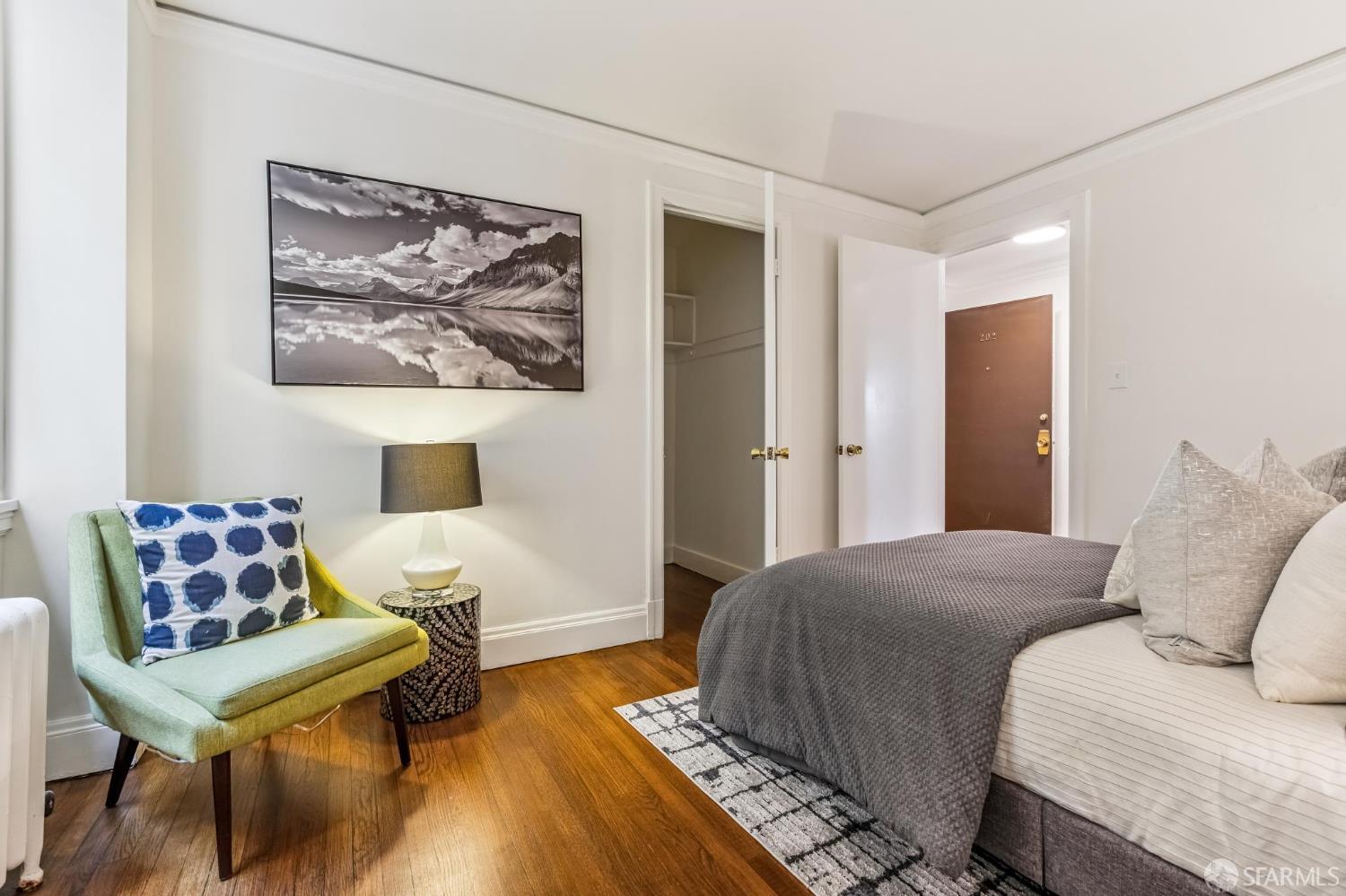 850 Powell Street, Unit 202 San Francisco, CA 94108 - Photo 39 of 51 a bedroom with a bed and wooden floor