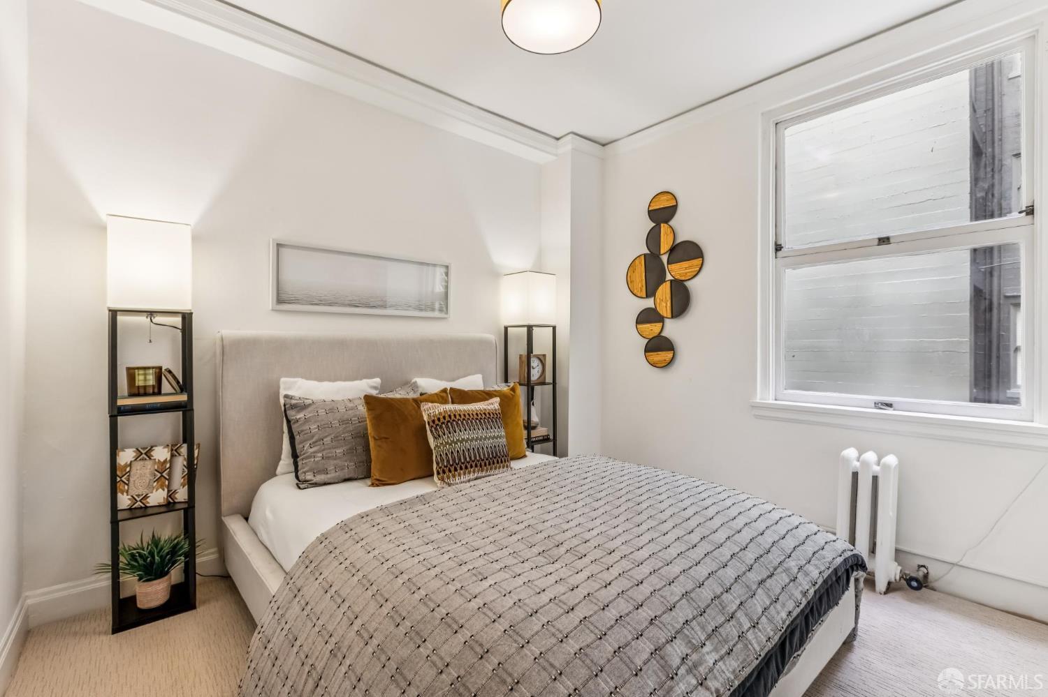 850 Powell Street, Unit 202 San Francisco, CA 94108 - Photo 43 of 51 a bedroom with a bed and wooden floor